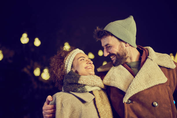 istock Young happy couple communicating while enjoying in winter walk at night. 1552550971