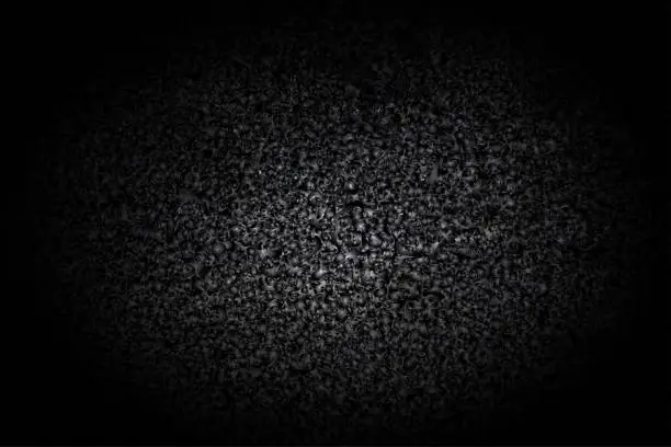 Vector illustration of Very dark shiny black grunge textured effect wall or asphalt road with coal tar on pebbles with abstract texture all over like glowing futuristic background or wallpaper with copy space for text