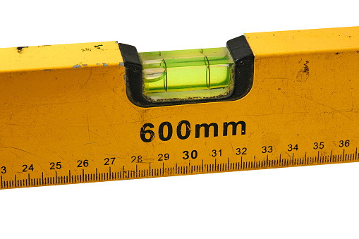 Old Water Level Gauge Ruler (Spirit Level) isolated on white background. Spirit Level is a device used for measuring the level of inclination horizontally (horizontal) and vertically (vertical).