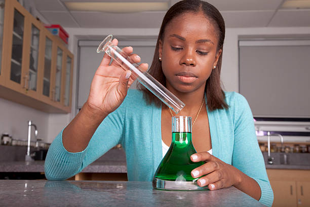 Student doing chemistry experiment stock photo