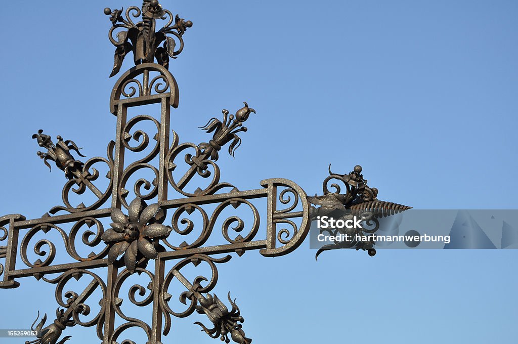 iron cross with blue sky part of a iron cross with blue sky Art And Craft Stock Photo