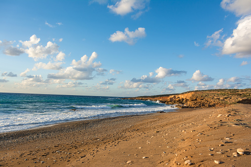 Beautiful view of the seashore at sunset in soft golden light. Toxeftra Beach, Cyprus.