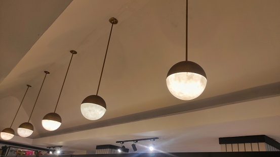 hanged ball-shape lamp decorations in ceiling of shop can make the room looks more aesthetic