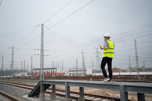 Young railway workers are inspecting the tracks