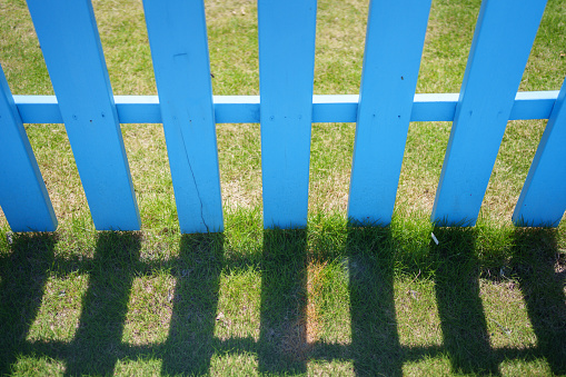 New wooden rural fence made of horizontal blue planks. Isolated with patch