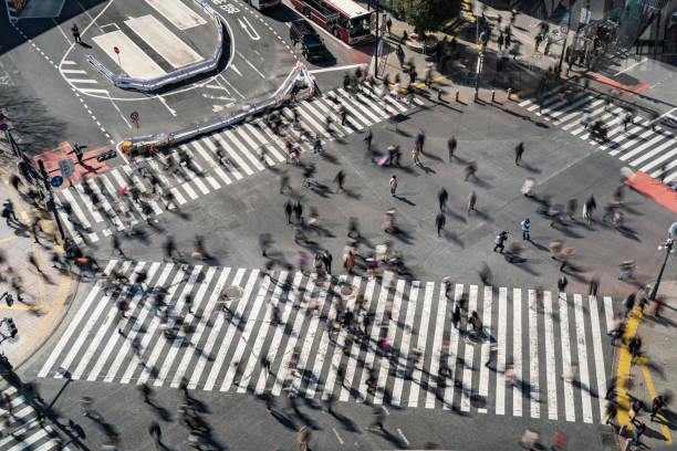 Shibuya crossing in Japan Shibuya crossing in Japan shot with long exposure technique tokyo crowds on the famous shibuya crossing japan stock pictures, royalty-free photos & images