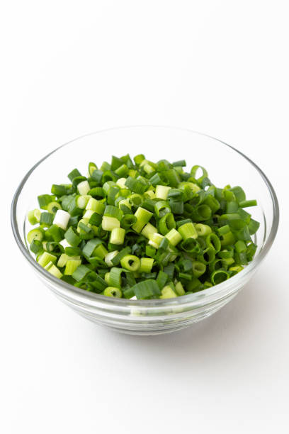 istock Green onions chopped on a white background. 1552602307