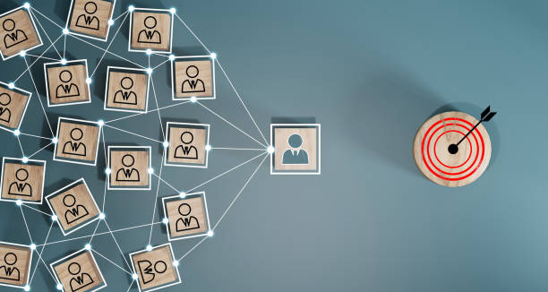 istock Red dartboard and black arrow connection linkage with human icon for customer focus target group and customer relation management concept. 1552602567