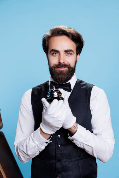 istock Bellhop with white gloves and bell 1552602631