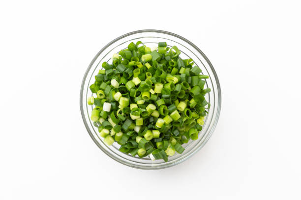 istock Green onions chopped on a white background. 1552602652