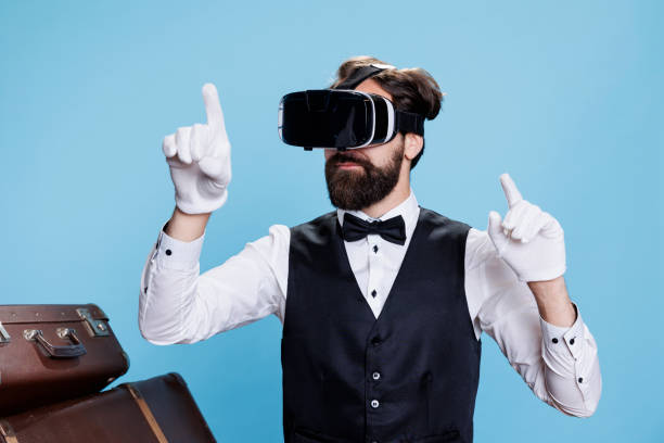 Professional bellhop posing with vr glasses on camera, having fun with 3d interactive vision and leveraging technology. Classy doorman employee using modern headset, suit and tie attire.