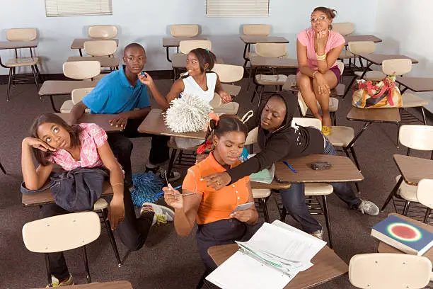 Photo of Highschool students messing in class during break