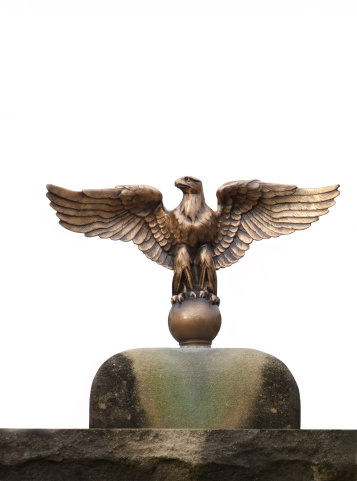 Statue of an eagle isolated against a white background.