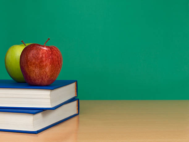 istock Apples on a stack of books on the table 155260783