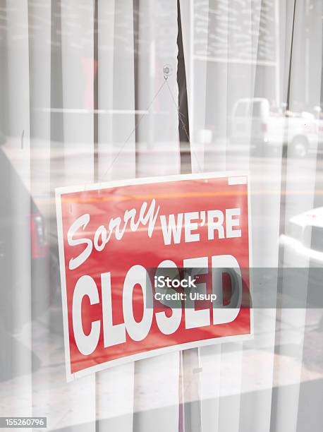 Sorry Were Closed Sign Surrounded By Reflections Of The Street Stock Photo - Download Image Now