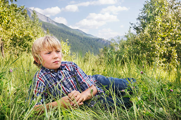 Little boy with a far away look stock photo