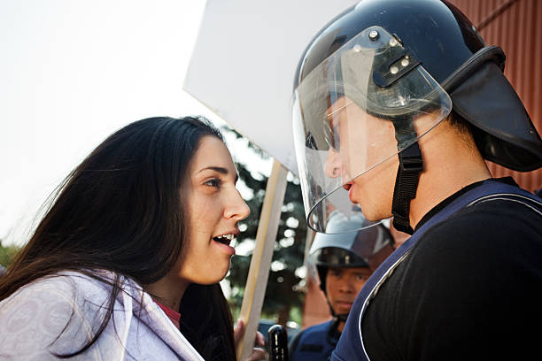 Student confronts officer Student protester confronts riot gear clad police officer. More  riot police stock pictures, royalty-free photos & images