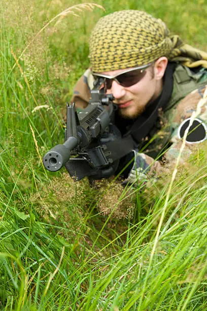 Photo of Sniper laying in a grass