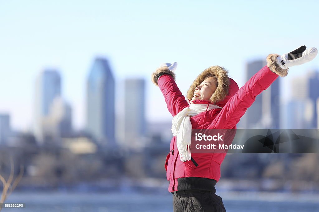 City winter woman happy City winter woman happy standing excited and elated with arms raised in joy. Beautiful young woman and Montreal City skyline, Quebec, Canada. Canada Stock Photo