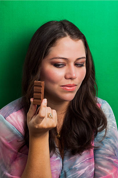 Girl looking for a chocolate bar with desire stock photo