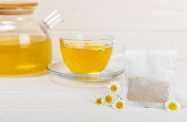 istock Chamomile tea in a  cup on a  texture background. Natural hour with chamomile flowers. Herbal tea. Immunity tea.Natural healer concept. Healthy detox drink.Close up. Place for text. 1552641567