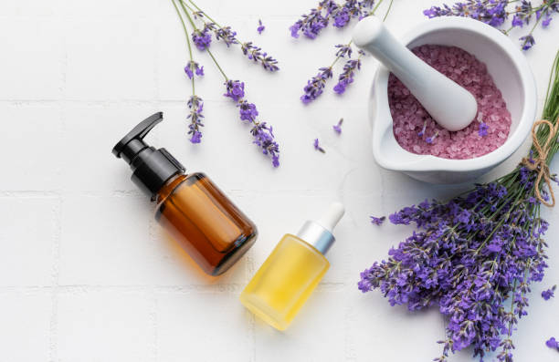 istock Lavender spa. Lavender salt, natural essential oil and fresh lavender on a white tile background. 1552652171