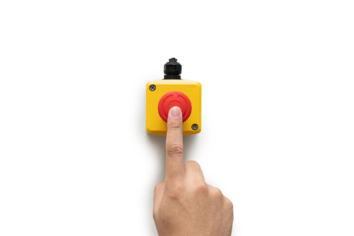 Stop Button and the Hand of Worker About to Press it. emergency stop button. Big Red emergency button isolated on white background.