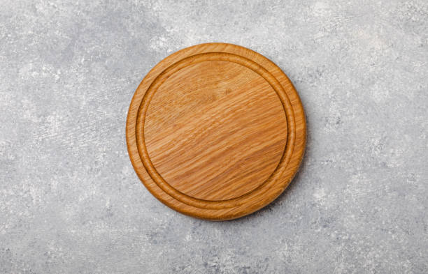istock Cutting board on a textured  kitchen table. Menu food card or recipes background concept.MOCKUP. Design. Place for text, copy space. The concept of food and cooking. 1552661844