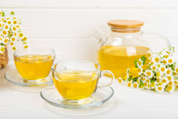 istock Chamomile tea in a  cup on a  texture background. Natural hour with chamomile flowers. Herbal tea. Immunity tea.Natural healer concept. Healthy detox drink.Close up. Place for text. 1552676528