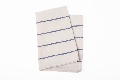 Kitchen towel .Cotton napkin isolated on white background. Picnic towel. Home textiles. Folded cloth.Food serving design element. Square napkin.