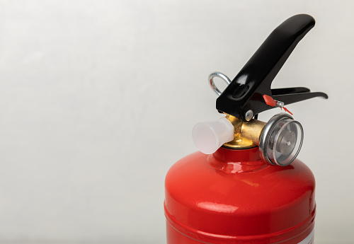 Fire extinguisher on a  background. Fire protection, home fire extinguisher. home security concept. Place for text. Copy space.banner