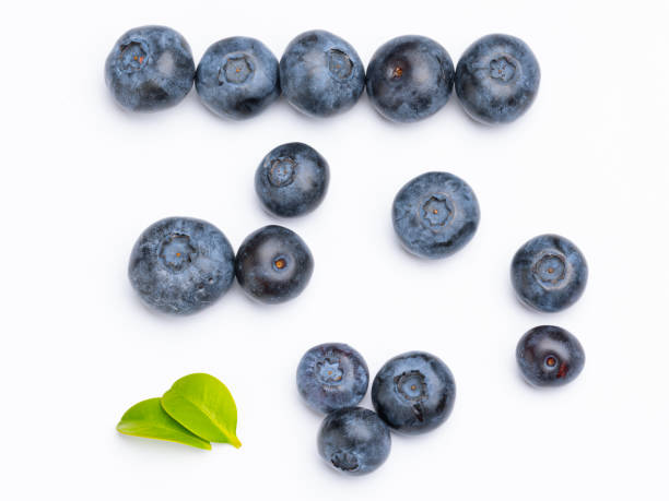 istock Fresh blueberries with blueberry leaves isolated on white background. View from above. Fresh raw berries 1552692789