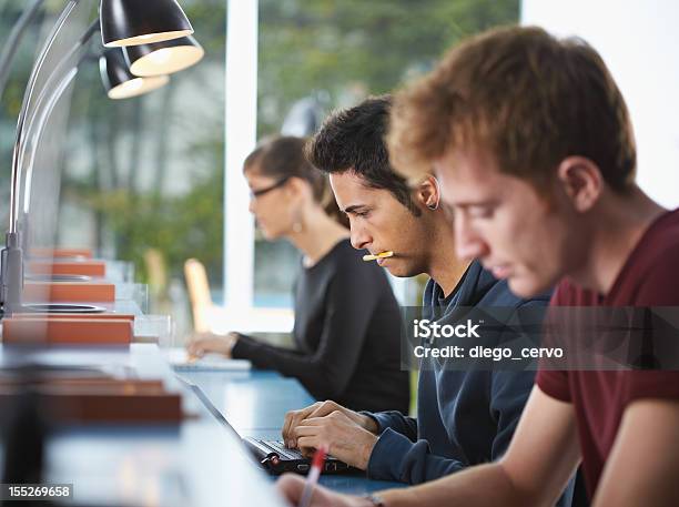 Group Of Three People In Library Stock Photo - Download Image Now - Group Of People, Looking Away, Serious