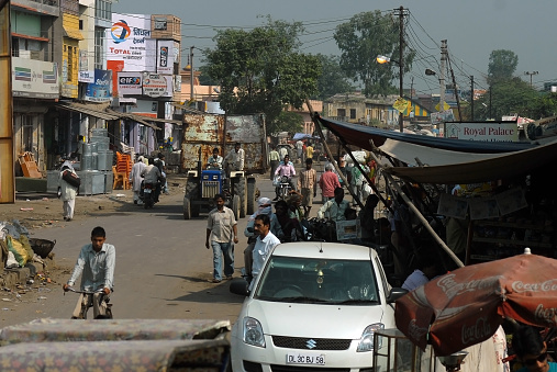 Urban downtown life on a sunny afternoon in the streets of New Delhi, India