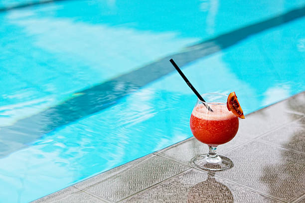 istock glass with drink costs on a pool side 155269748