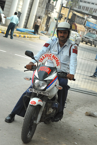 Traffic patrol officer on his motorcycle on a sunny day in New Delhi, India