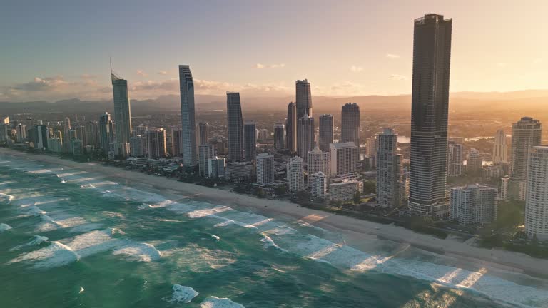 4K Aerial view Real time Footage of above Main Beach, Broadbeach, Surfers Paradise skyline with luxury Hotel and Apartment sea beach in Gold Coast at the sunset time, Australia