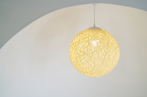 Round ceiling lamp made of thread on white background