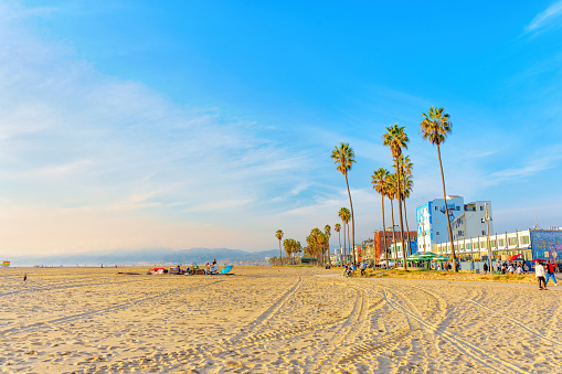 Los Angeles, California - December 29, 2022: Sunny Winter Day at Venice Beach. People Walking and Cycling.