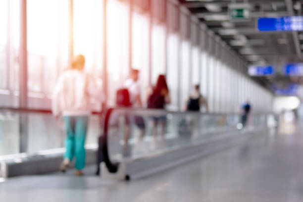 Walkway in modern airport terminal blur for background. Walkway in modern airport terminal blur for background. airport travelator stock pictures, royalty-free photos & images