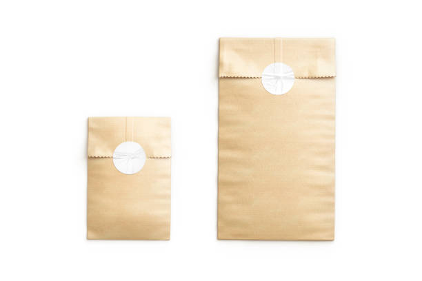 istock Blank craft rectangle paper bag with sticker mockup, top view 1552751429