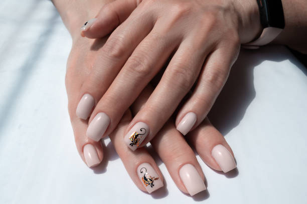 istock Delicate cream manicure with an abstract pattern for women 50+ 1552758977