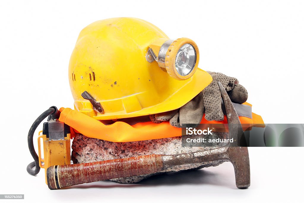 Underground safety gear Equipent for underground exploration work (hardhat, mining headlamp, geological hammer...) isolated on white. Mining - Natural Resources Stock Photo