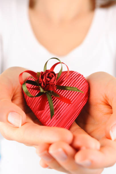 istock Young woman holding a red heart shaped gift 155276895