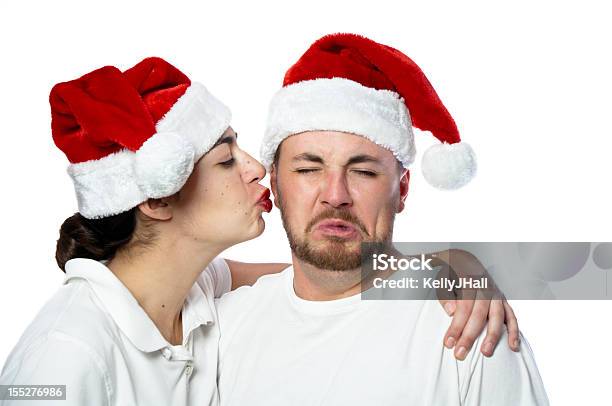 Unhappy Young Man Getting Kissed On Cheek Stock Photo - Download Image Now - Adult, Adults Only, Christmas