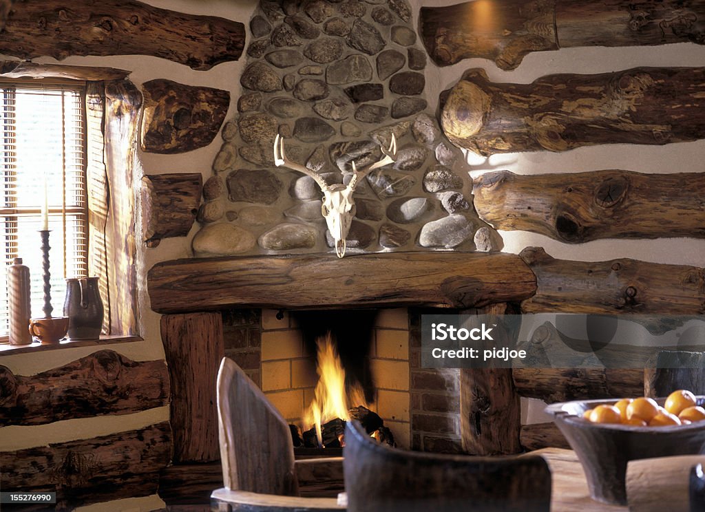 log fire in cabin interior of log cabin with burning log fire in fireplace Log Cabin Stock Photo