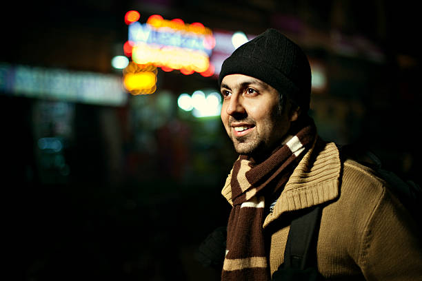 istock Happy young man with backpack in city market at night 155277217