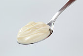 A teaspoon with a dollop of thick cream on it