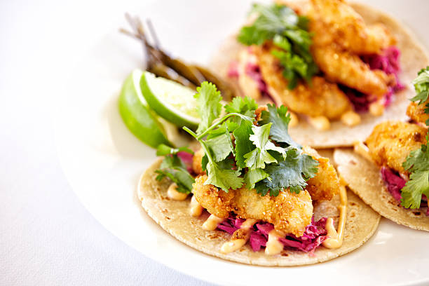 Close up of fish tacos on a plate Close up of fish tacos on a plate.  Horizontal shot. sauce photos stock pictures, royalty-free photos & images