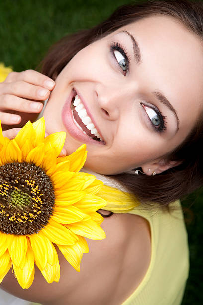 istock Young female holding a sunflower 155277589